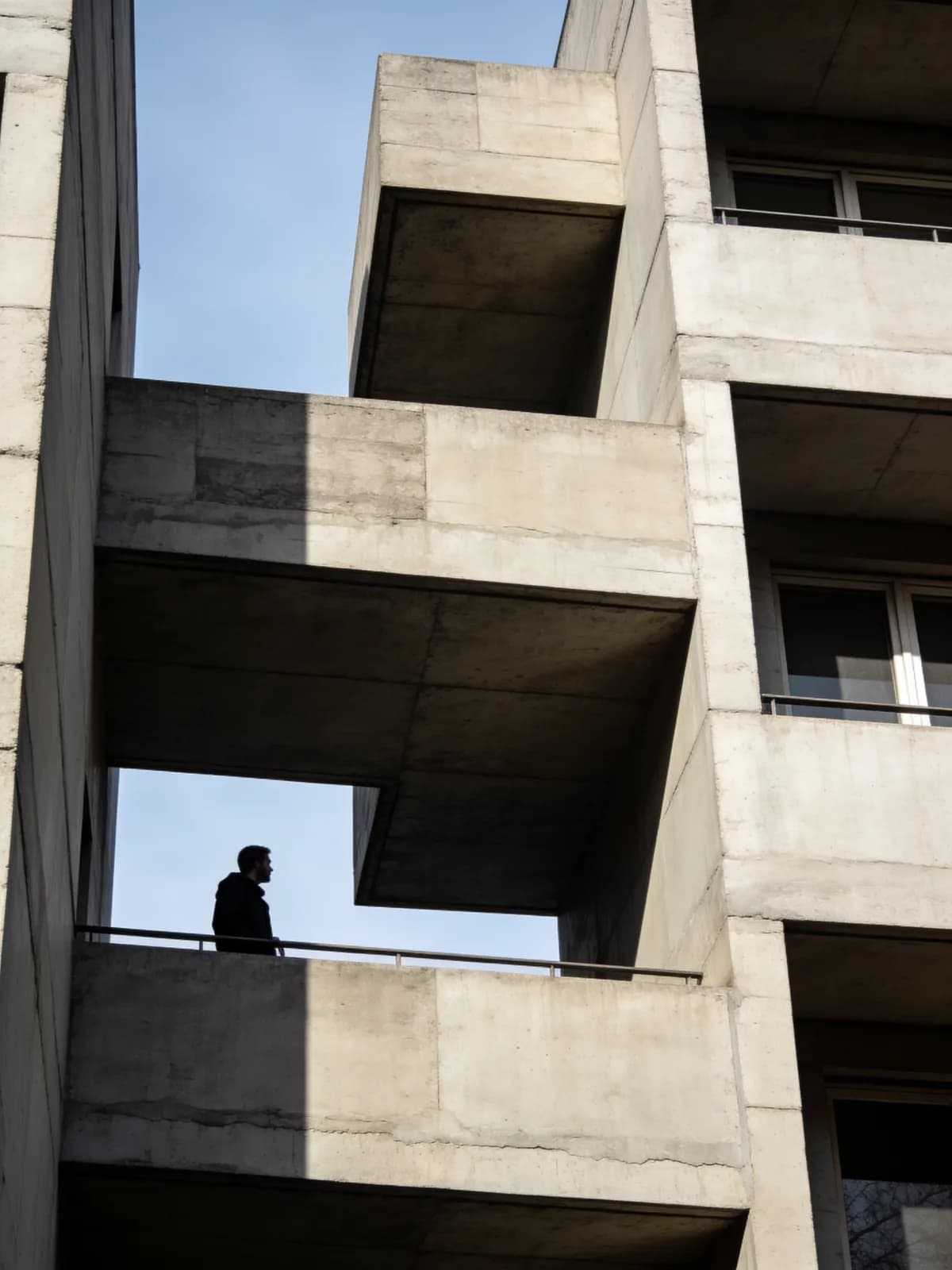 Brutalist concrete building against a blue sky
